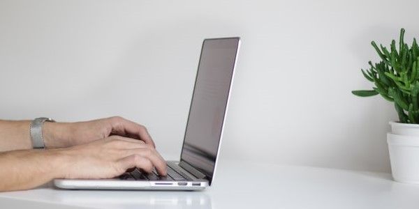 Person typing on a laptop to start a loan application