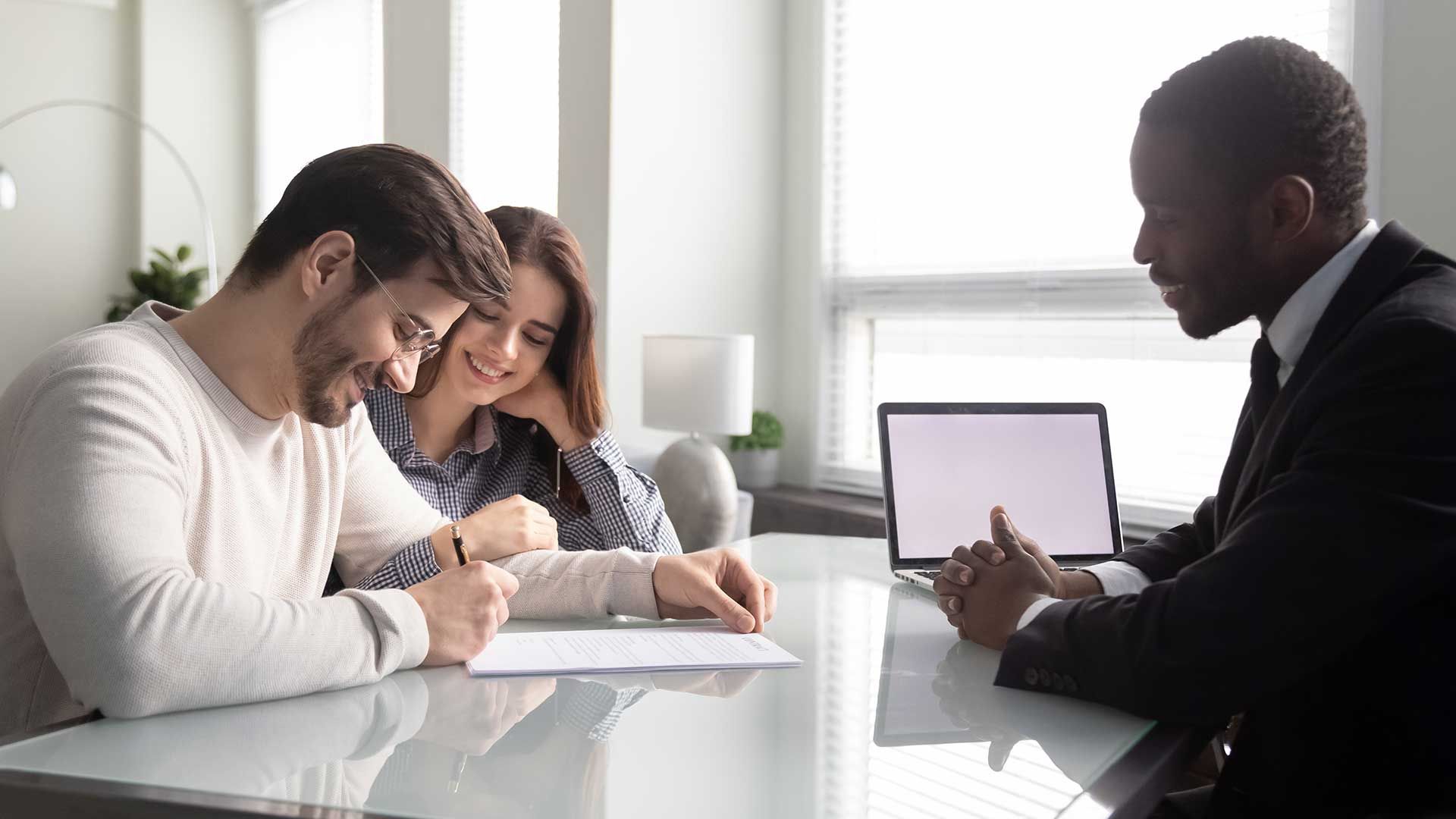 Couple reviewing mortgage paperwork at a table